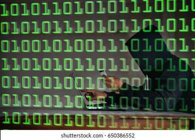 Terrorist hacker in black jacket try to hack data from internet by using computer notebook with binary code digit in background.