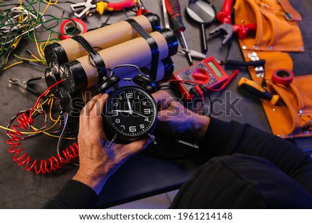 Terrorist making bomb at table