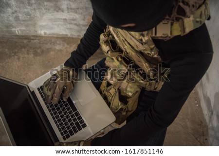 Terrorist man cyber hacker hacking internet to access steal information by laptop computer, robber criminal concept