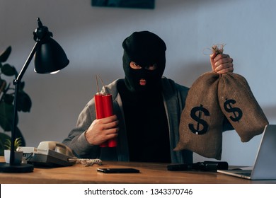 Terrorist In Mask Holding Dynamite And Money Bags In Room