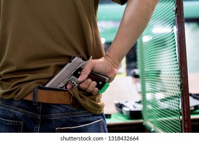 Terrorist thief man holding short gun in his hand. Hidden gun on back side body. 