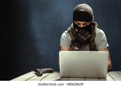 Terrorist Working On His Computer. Concept About Terrorism