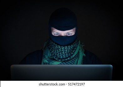 Terrorist Working On His Computer. Concept About International Crisis, War And Terrorism