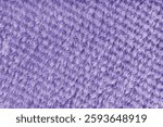 Terry cloth, diagonal striped pattern purple towel texture background. Soft fluffy textile bath or microfiber beach towel material. Top view, close up, macro.