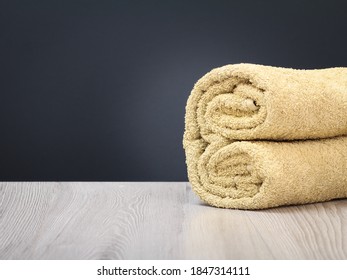 Terry Towel As A Spa Composition On The Wooden Boards And The Gray Background.