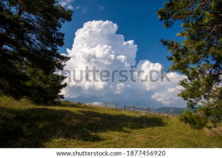 Teruel Spain blue sky with cumulus cloud forming over the mountains.