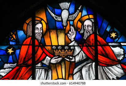 TERVUREN, BELGIUM - MARCH 13, 2017: Stained Glass in the Church of Tervuren, Belgium, depicting the Holy Trinity - Father, Son and Holy Spirit.