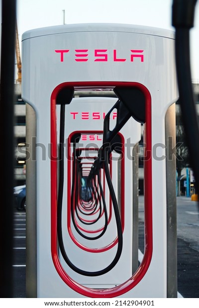 Tesla charging station to welcome electric\
car owners. Turin, Italy - April 2022\
