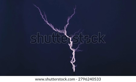 Tesla coil generating high voltage electricity showing a vibrant purple spark discharge