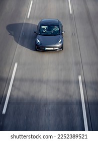 Tesla driving fast down a highway