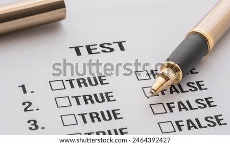 test answer sheet with two items: false or true. Test answer sheet and pen on the desk