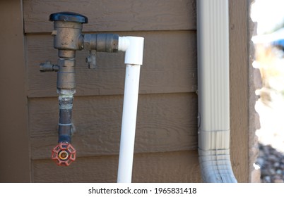 Test Cocks, Shut Off Valves, And Vacuum Breaker To A Lawn Sprinkler Irrigation System On The Outside Of A Residential House