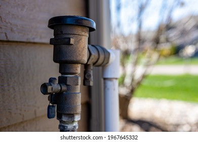 Test cocks, shut off valves, and vacuum breaker to a lawn sprinkler irrigation system on the outside of a residential house