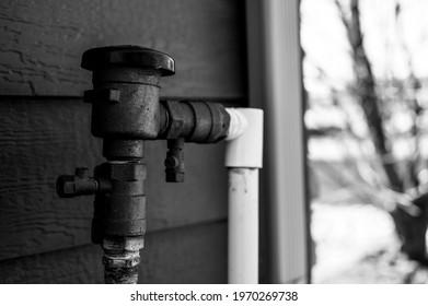 Test Cocks, Shut Off Valves, And Vacuum Breaker To A Lawn Sprinkler Irrigation System On The Outside Of A Residential House