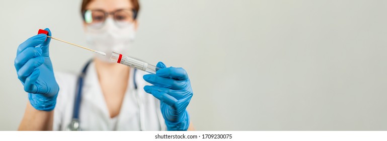 Test for coronavirus Covid-19. Female doctor or nurse doing lab analysis of a nasal swab in a hospital laboratory. - Shutterstock ID 1709230075