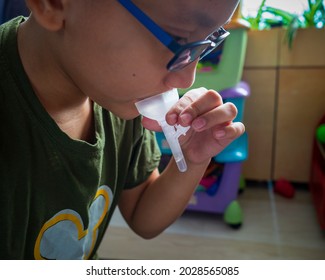 Test Covid At Home. A Young Boy Self Test For COVID-19 Home Test Kit. Coronavirus Saliva Test For Infection SARS-CoV-2 Testing. Fast Corona Kit