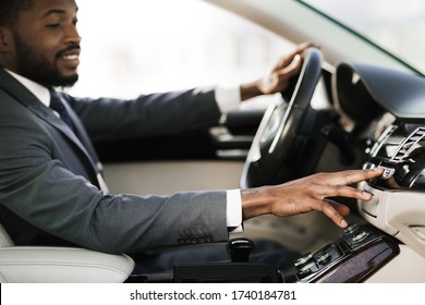 Test Drive. Relaxed Black Man Driving Car Listening To Music On Radio Sitting In New Automobile. Shallow Depth, Selective Focus