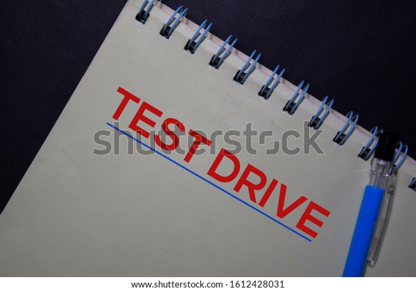 Test Drive\
write on a book isolated on black\
table.