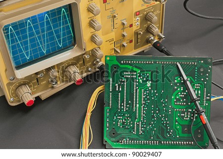 Test electronic board with oscilloscope - instruments of electronic service lab