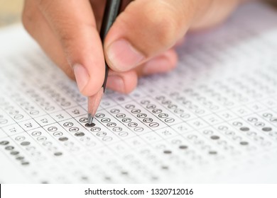 Test Exam Concept, Pencil Writing Answer On Paper Answer Of Question In Examination Test. It Assessment Intended To Measure Knowledge, Skill, Aptitude, Physical Fitness, Or Classification Students