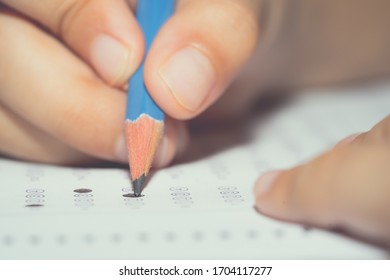 Test Exam Concept, Pencil Writing Answer On Paper Answer Of Question In Examination Test. It Assessment Intended To Measure Knowledge, Skill, Aptitude, Physical Fitness, Or Classification Students