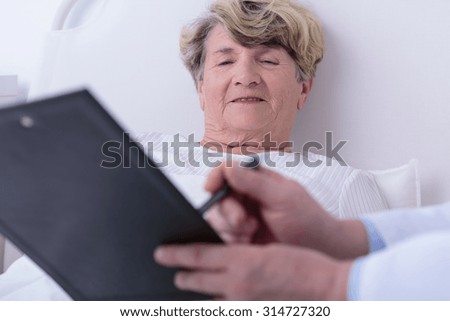 Similar – Female doctor showing results of a medical test on the tablet