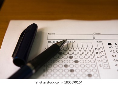 Test Score Sheet Or Bubble Test Sheet With A Pen On Table.