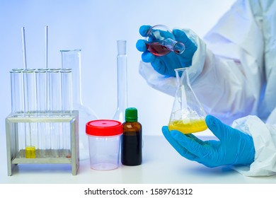 Test tube in the hands. Concept - laboratory glassware. Test tubes for chemicals. Medical test tubes in the hands of a laboratory assistant. Equipment for the laboratory. Sale of lab glassware