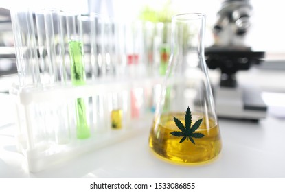 Test Tube With Natural Extract Cbd Oil In Chemisrtry Lab Research Background Closeup. Medical Marijuana Concept