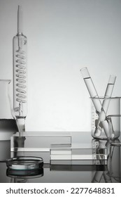 Test tube, petri dish filled with water and laboratory glassware displayed with rectangle transparent podium. Blank space for product advertisement