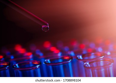 Test Tube Row. Concept Of Medical Or Science Laboratory, Liquid Drop Droplet With Dropper In Blue Red Tone Background, Close Up, Macro Photography Picture.