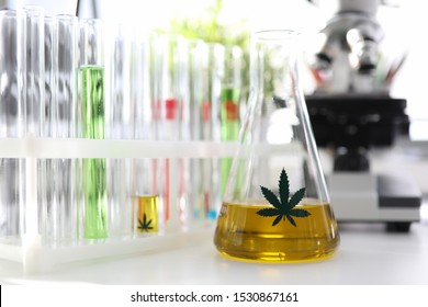 Test Tube With Yellow Cbd Oil In Chemisrtry Lab Research Background Closeup. Medical Marijuana Concept
