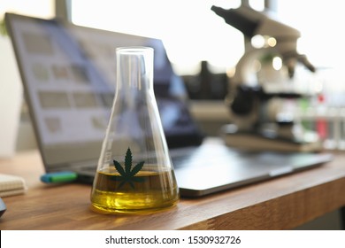 Test Tube With Yellow Cbd Oil In Chemisrtry Lab Research Background Closeup. Medical Marijuana Concept