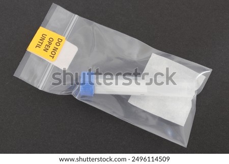 Test tubes for at home testing kit isolated against dark background.