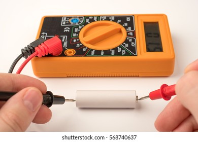 Testing battery with digital multimeter - Shutterstock ID 568740637