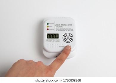 Testing Carbon Monoxide Detector On A White Wall. Stay Home Safe. Home Control And Security.  CO Detector