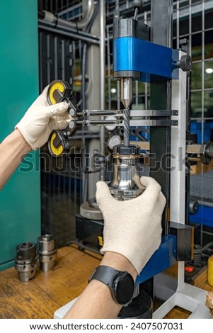 Testing and checking cutting tools for runout on a stand in the centers using indicators.