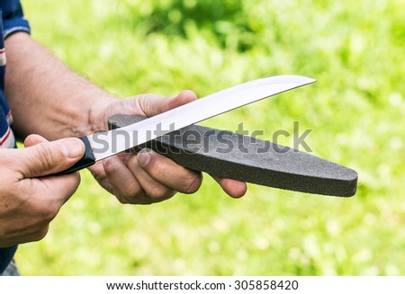 Testing a knife after sharpening with a whetstone