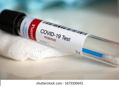 Testing for presence of coronavirus. Tube containing a swab sample that has tested positive for COVID-19.