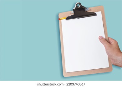 Testing System concept. Hands hold a paper on clipboard.