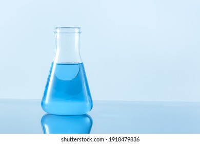 Test-tube with blue liquid isolated on white. - Shutterstock ID 1918479836