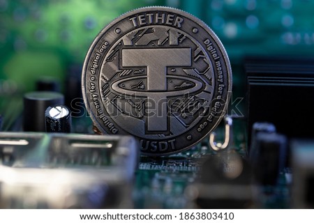Tether USDT cryptocurrency physical coin placed on micro scheme. Macro Shot.