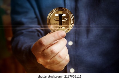 Tether USDT stablecoin cryptocurrency golden coin in hand abstract concept - Shutterstock ID 2167936115