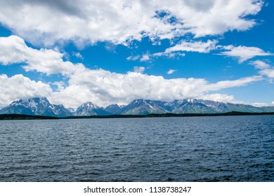 The Teton Mountain at Jackson Lake Dam near Grand Teton National Park, Wyoming on a sunny and partly cloudy day