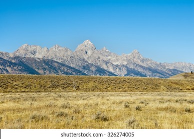 The Teton Peaks And Sagebrush Steppe Of Wyoming Near Jackson Hole In Autumn.