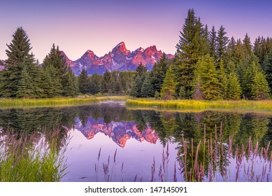The Teton range's reflection upon the Snake River.  Photographed at dawn at Schwabacher's Landing in Grand Teton National Park, WY