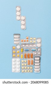 Tetris Game From Medical Pills, Top View On Blue Background. Health Care Concept As A Challenge Or Quest. Treatment Blisters Of Tablets In Shape Of Block Game. Healthcare Pharmaceutical Background