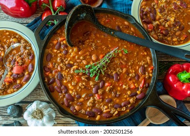 Tex Mex Bean Stew With Minced Meat Served In A Cast Iron Pan On Rustic And Wooden Table Background From Above