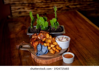 Tex mex Chicken dinner with coleslaw and hot sauce on wood serving tray