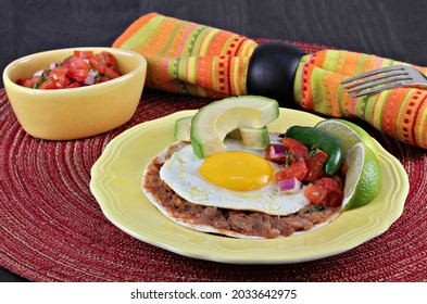 Tex Mex Huevos Rancheros, With Pico De Gallo, Sliced Avocado On A Tortilla With Refried Beans.  